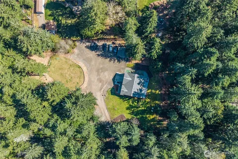 an aerial view of residential house with outdoor space and swimming pool
