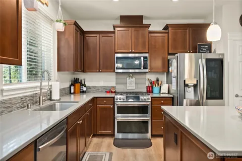 a kitchen with a sink a stove and a refrigerator