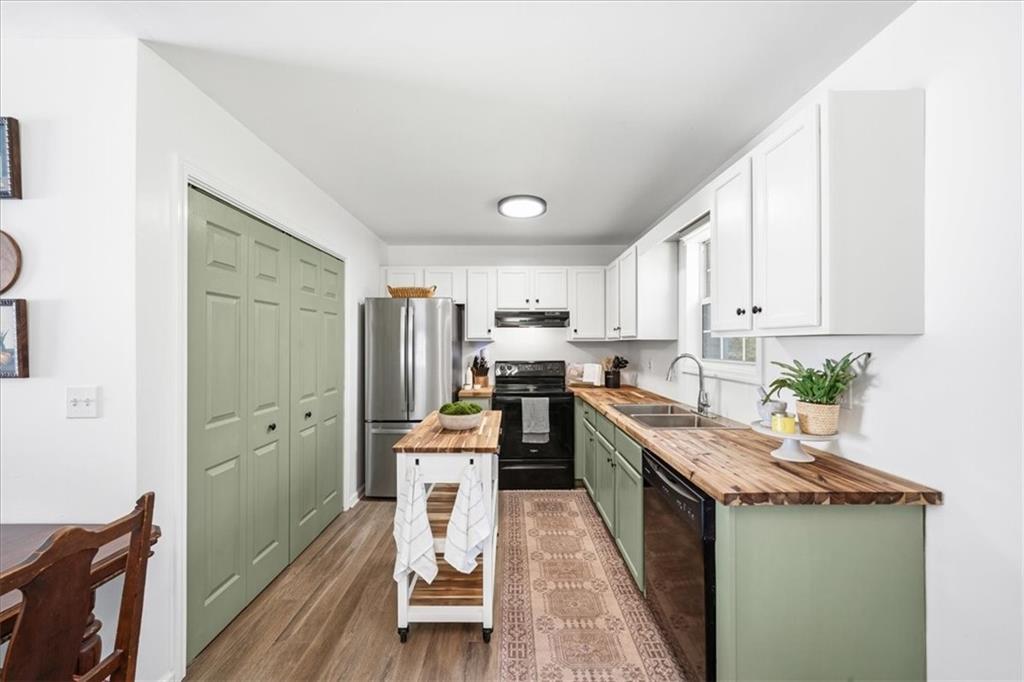 a kitchen with granite countertop a sink stove and refrigerator