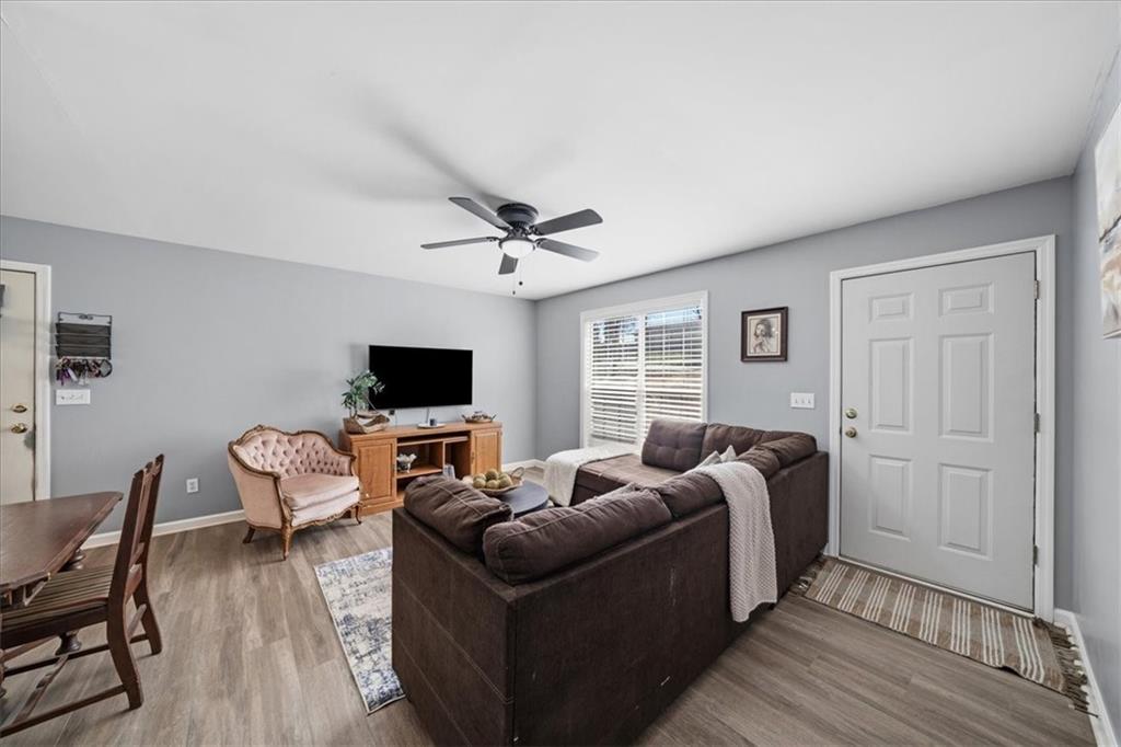 5638 Nacoochee Street Lula, GA 30554 - Photo 6 of 29 a living room with furniture wooden floor and a flat screen tv