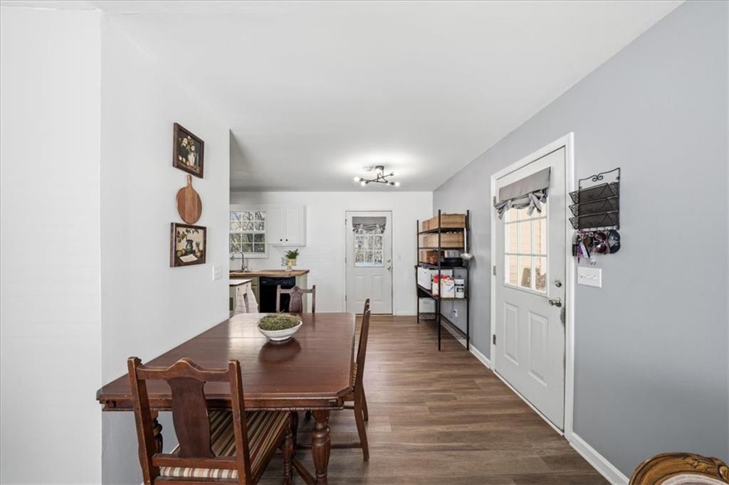 5638 Nacoochee Street Lula, GA 30554 - Photo 9 of 29 a view of a dining room with furniture and wooden floor