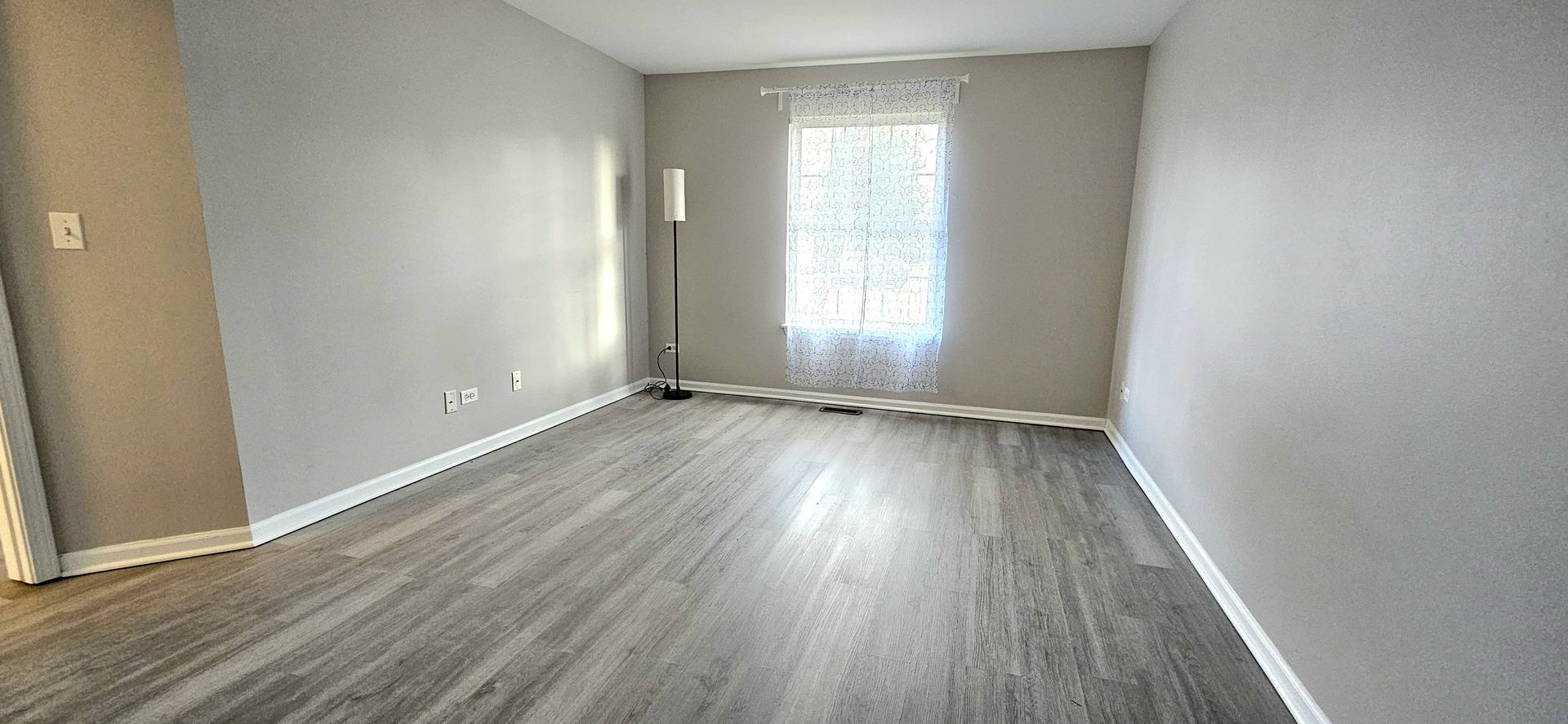 1248 North Red Oak Circle, Unit 2 Round Lake Beach, IL 60073 - Photo 13 of 21 an empty room with wooden floor and windows
