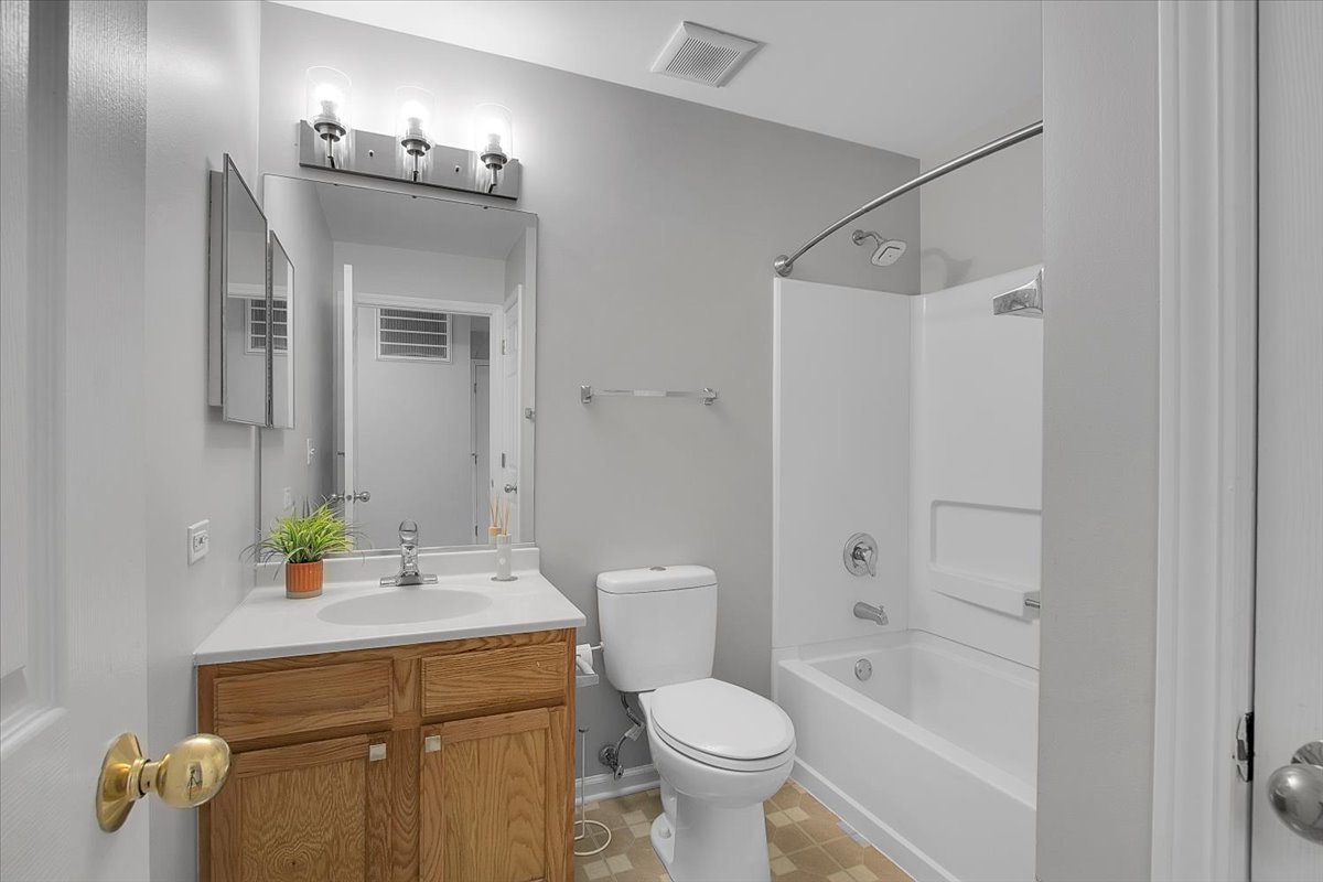 1248 North Red Oak Circle, Unit 2 Round Lake Beach, IL 60073 - Photo 15 of 21 a bathroom with a sink toilet and shower