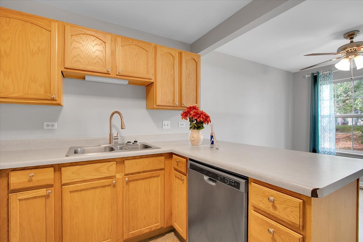 1248 North Red Oak Circle, Unit 2 Round Lake Beach, IL 60073 - Photo 6 of 21 a kitchen with stainless steel appliances granite countertop a sink a refrigerator and cabinets