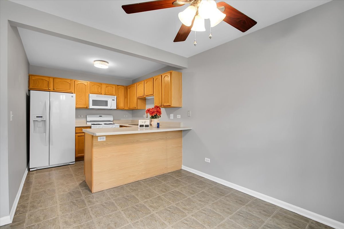 1248 North Red Oak Circle, Unit 2 Round Lake Beach, IL 60073 - Photo 7 of 21 a view of kitchen with stainless steel appliances cabinets and window