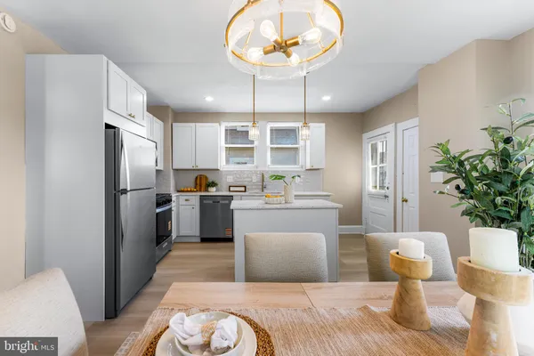 a kitchen with stainless steel appliances granite countertop a refrigerator a oven a sink a stove and island