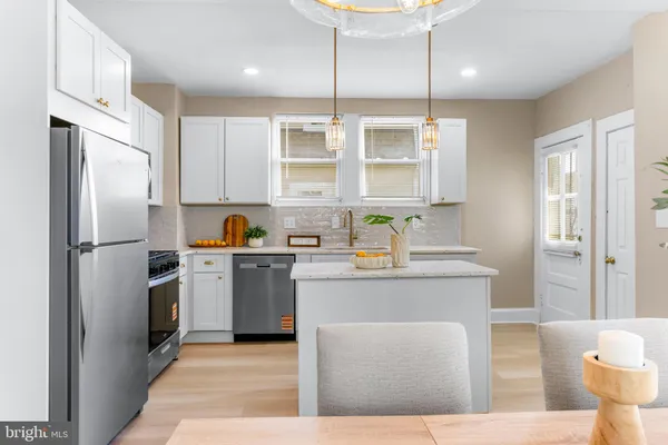 a kitchen with a refrigerator and a sink