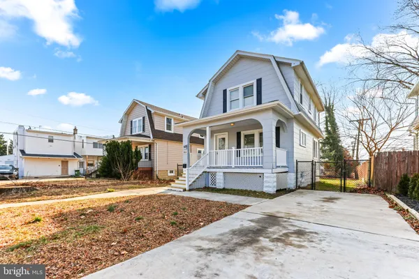 a front view of a house with a yard covered with snow