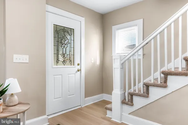 a view of entryway and hall with wooden floor