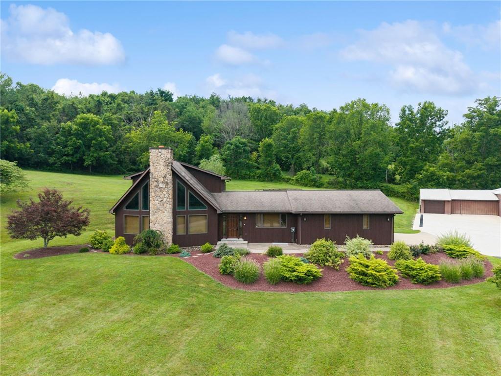 a view of a house with garden and yard