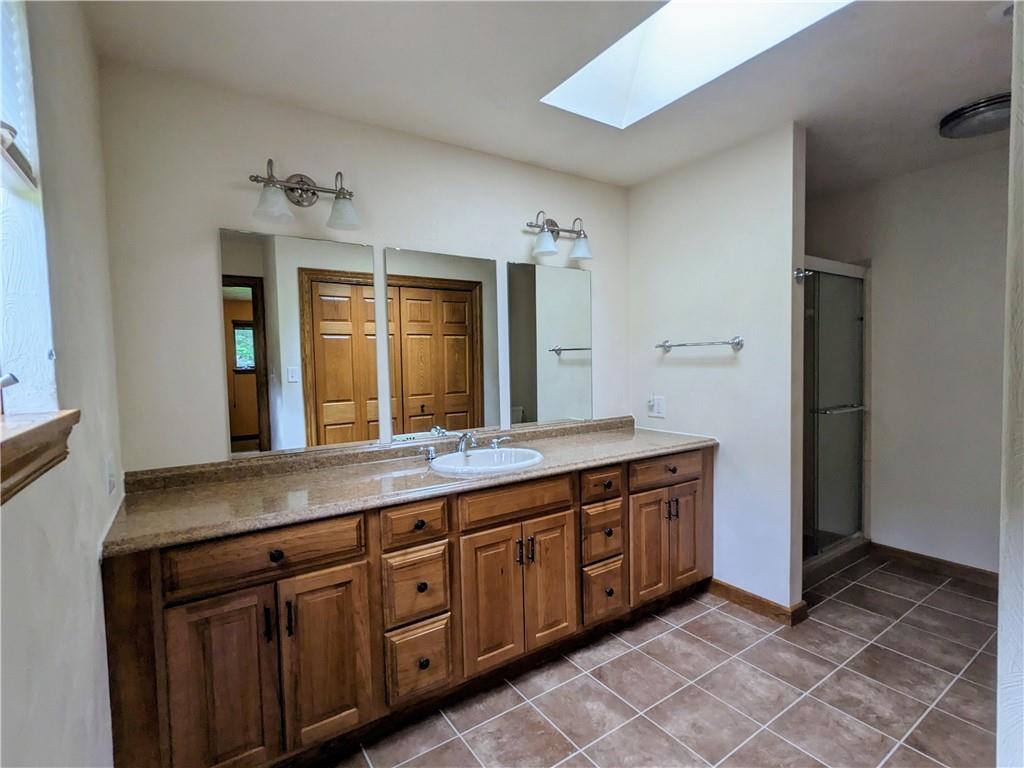 350 American Legion Road Latrobe, PA 15650 - Photo 15 of 45 a spacious bathroom with a granite countertop sink and a mirror