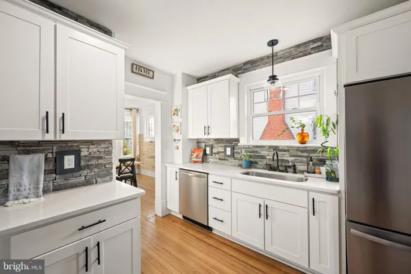a kitchen with stainless steel appliances a sink stove and refrigerator