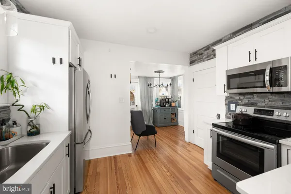 a kitchen with a refrigerator and a sink