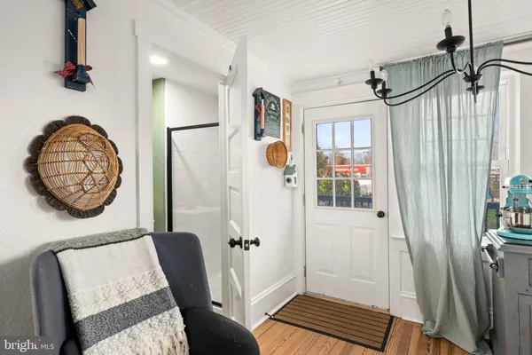 a view of a hallway with elevator and front door
