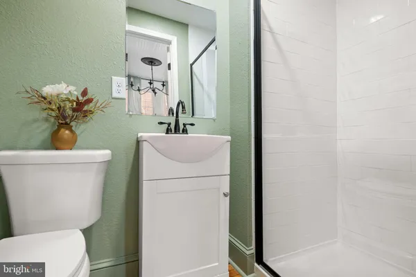 a bathroom with a toilet a sink and mirror