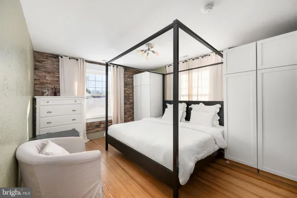 a bedroom with a bed and window