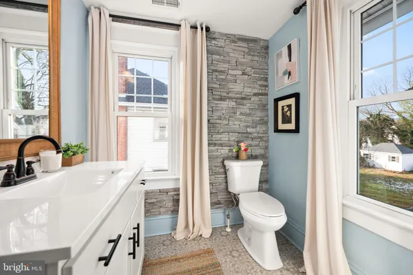 a bathroom with a sink a toilet and a shower