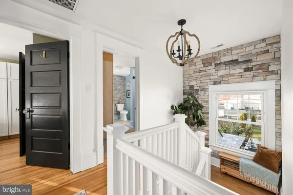 a view of a hallway to a livingroom with furniture