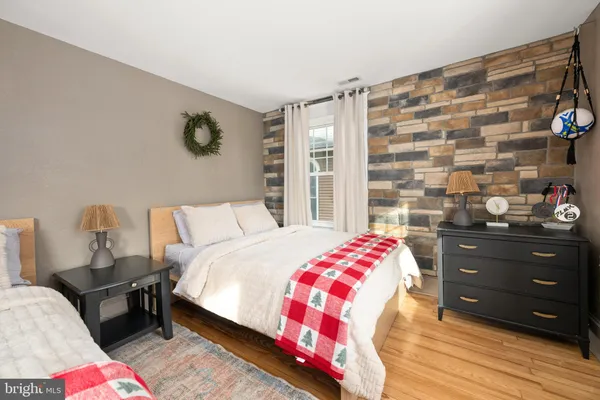a bedroom with a bed and a bookshelf