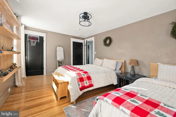 a bedroom with two beds and a dresser