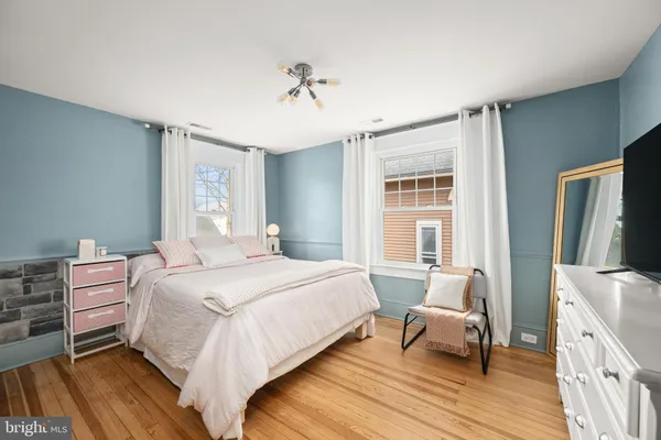 a bedroom with a bed and a dresser