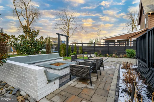 a view of a roof deck with couches and wooden floor