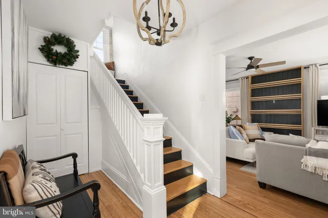 a view of entryway and hall with wooden floor