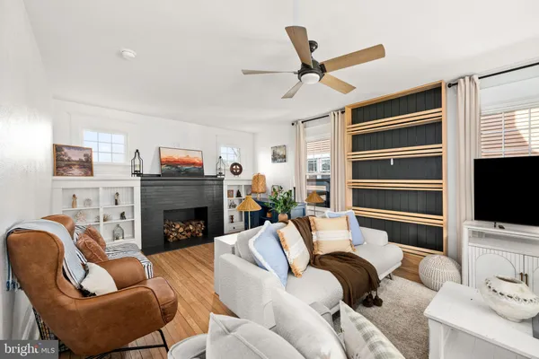 a living room with furniture a fireplace and a flat screen tv