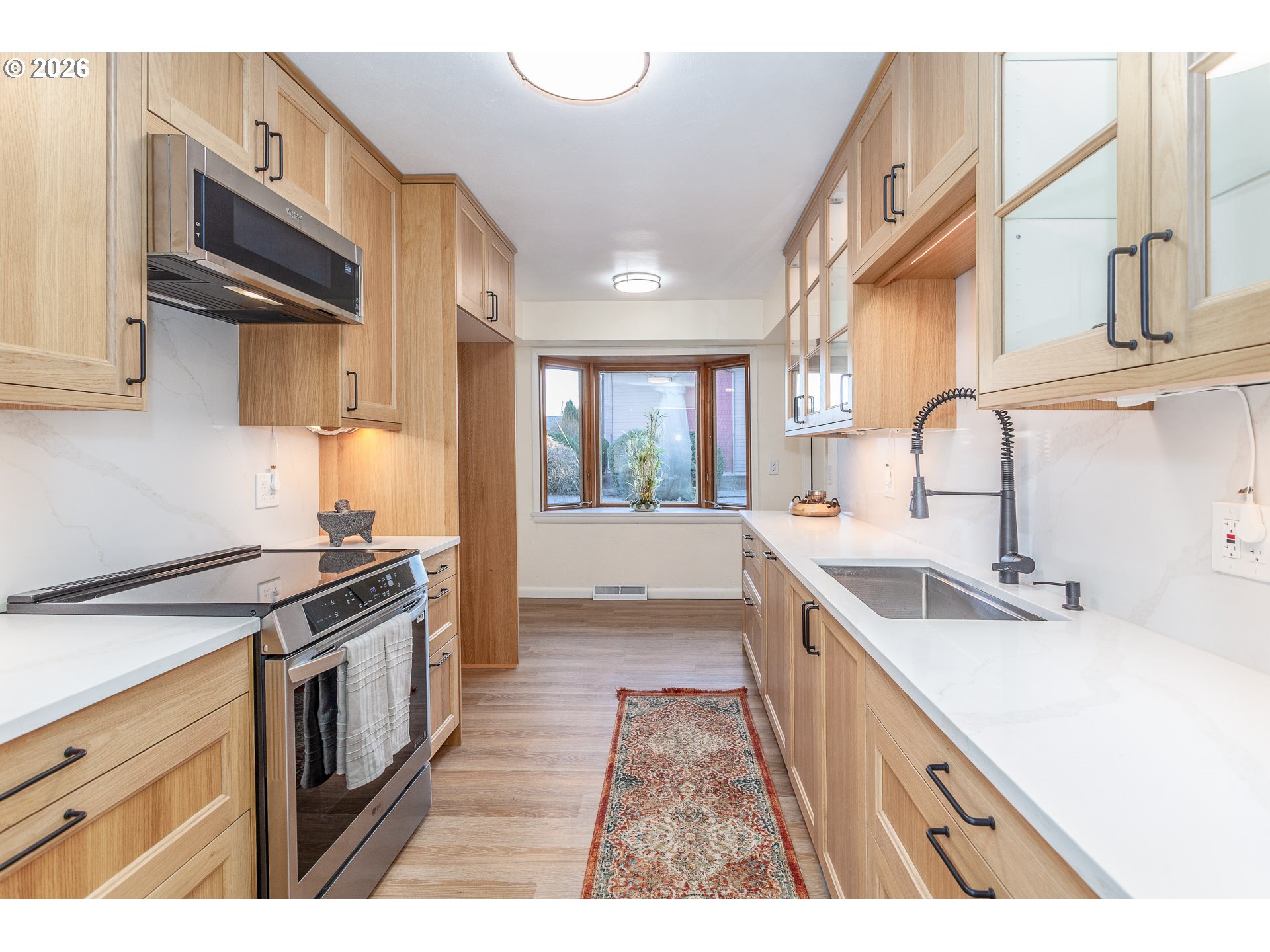 6805 Northeast Multnomah Street Portland, OR 97213 - Photo 11 of 44 a kitchen with a sink stove and cabinets