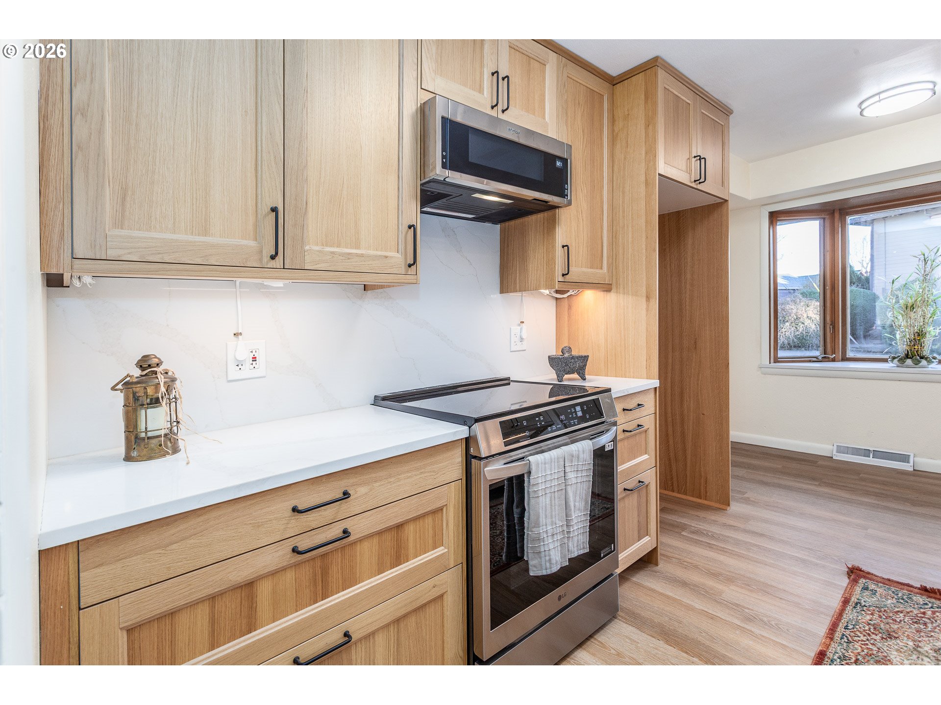 6805 Northeast Multnomah Street Portland, OR 97213 - Photo 12 of 44 a kitchen with stainless steel appliances granite countertop a stove a sink and a microwave