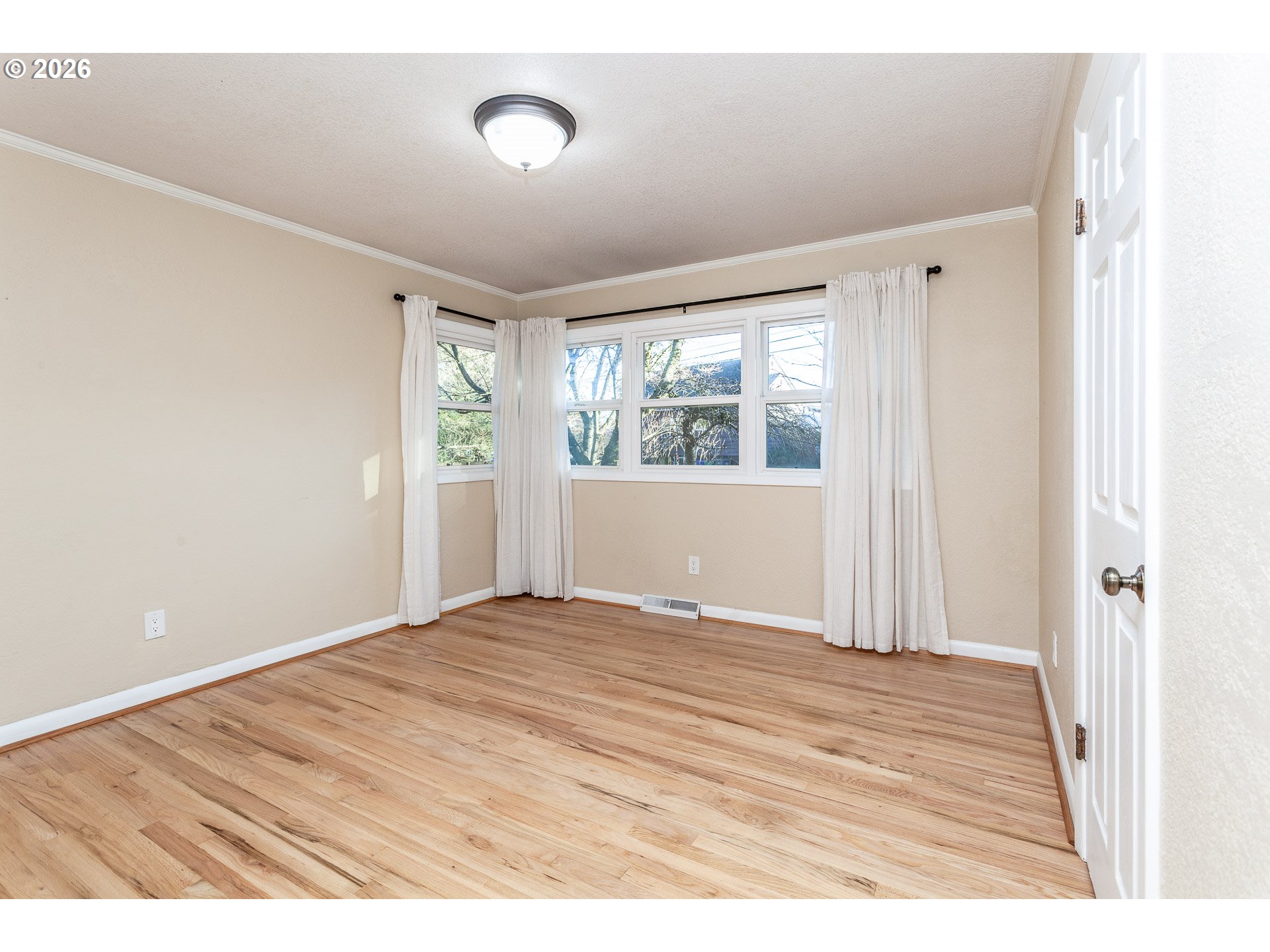 6805 Northeast Multnomah Street Portland, OR 97213 - Photo 16 of 44 a view of empty room with wooden floor and fan