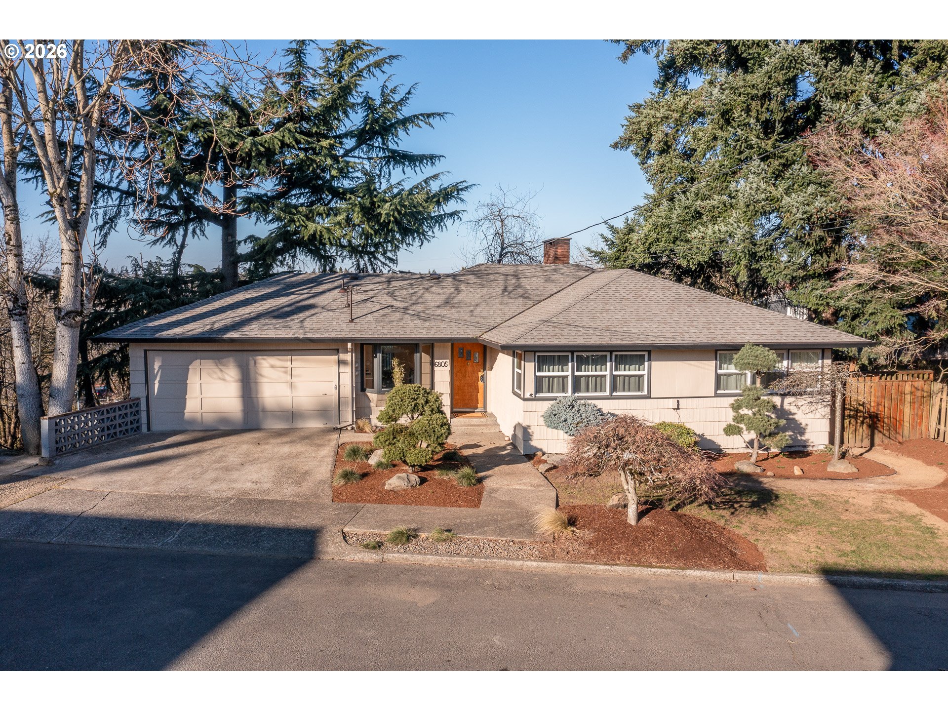 6805 Northeast Multnomah Street Portland, OR 97213 - Photo 2 of 44 a backyard of a house with table and chairs under an umbrella