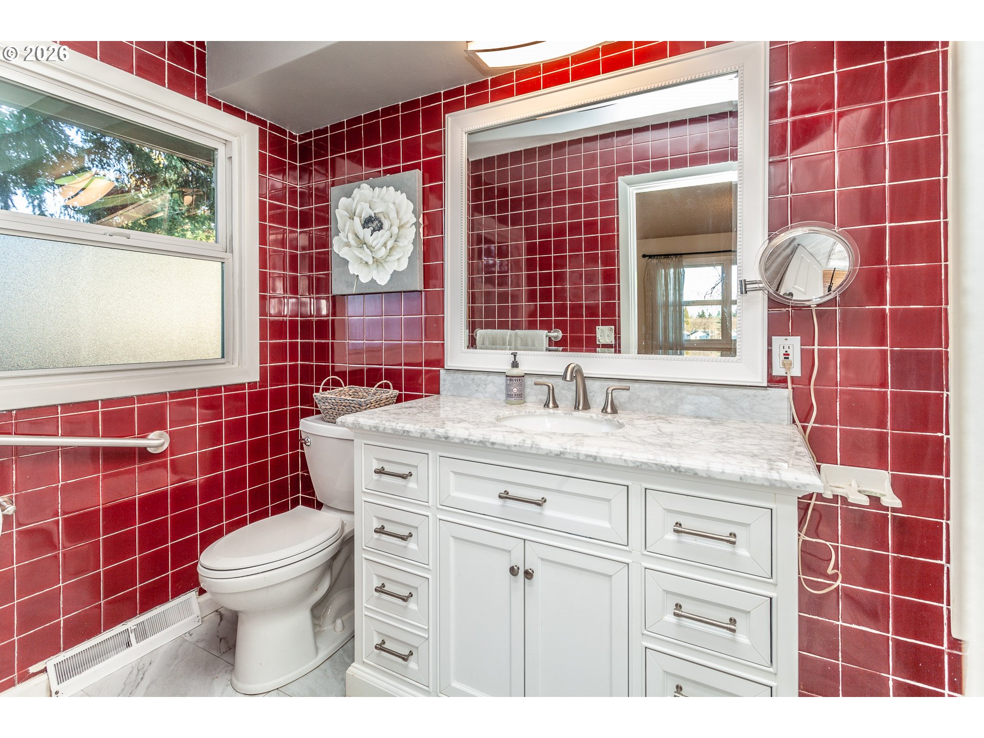 6805 Northeast Multnomah Street Portland, OR 97213 - Photo 23 of 44 a bathroom with a granite countertop toilet a sink and a mirror