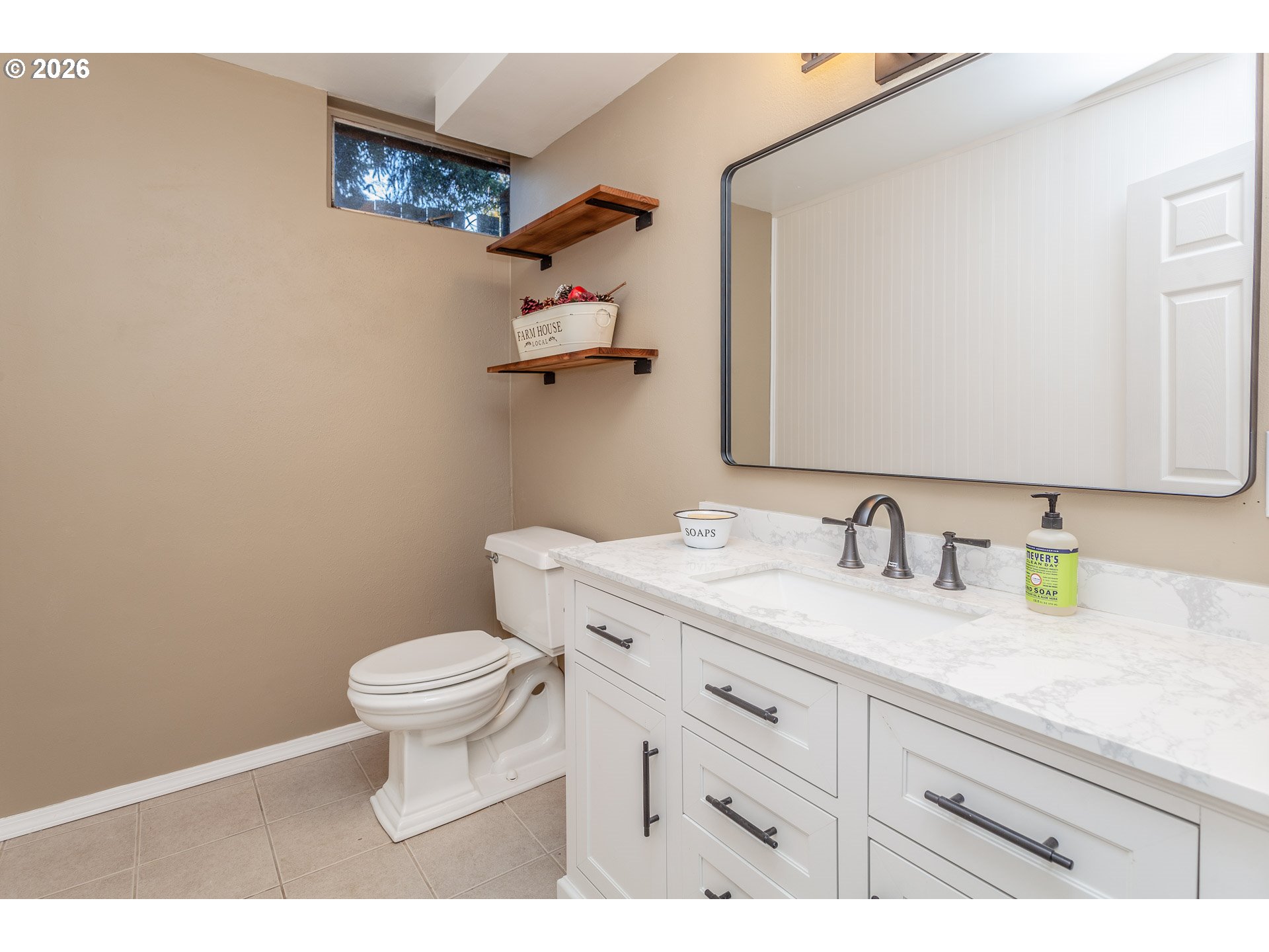 6805 Northeast Multnomah Street Portland, OR 97213 - Photo 33 of 44 a bathroom with a granite countertop sink mirror vanity and toilet