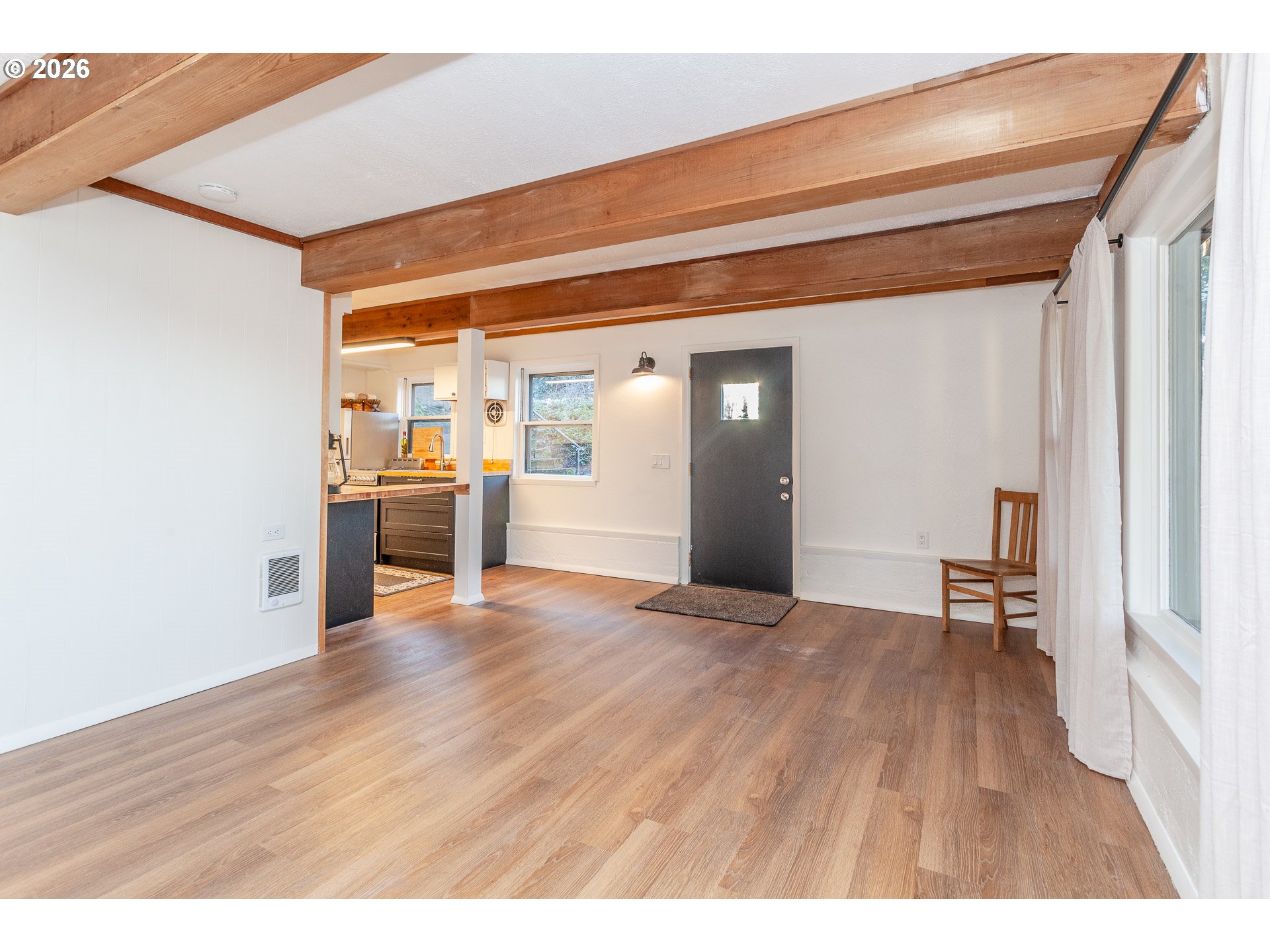 6805 Northeast Multnomah Street Portland, OR 97213 - Photo 36 of 44 a view of empty room with wooden floor and windows