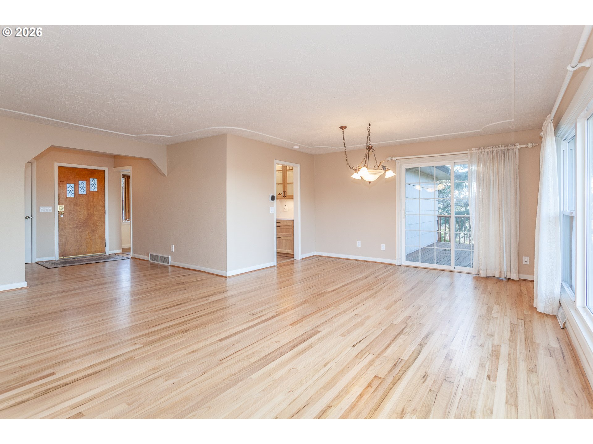 6805 Northeast Multnomah Street Portland, OR 97213 - Photo 4 of 44 wooden floor in an empty room with a window