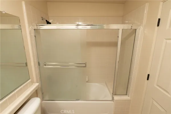 a front view of a house with a yard and potted plants