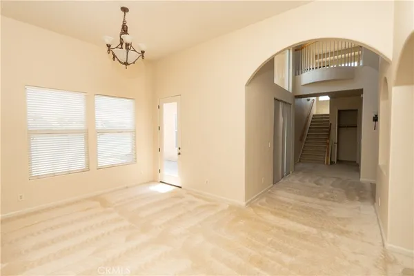 a view of an empty room with a fireplace and a window