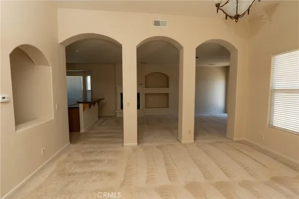 a view of an empty room with glass door