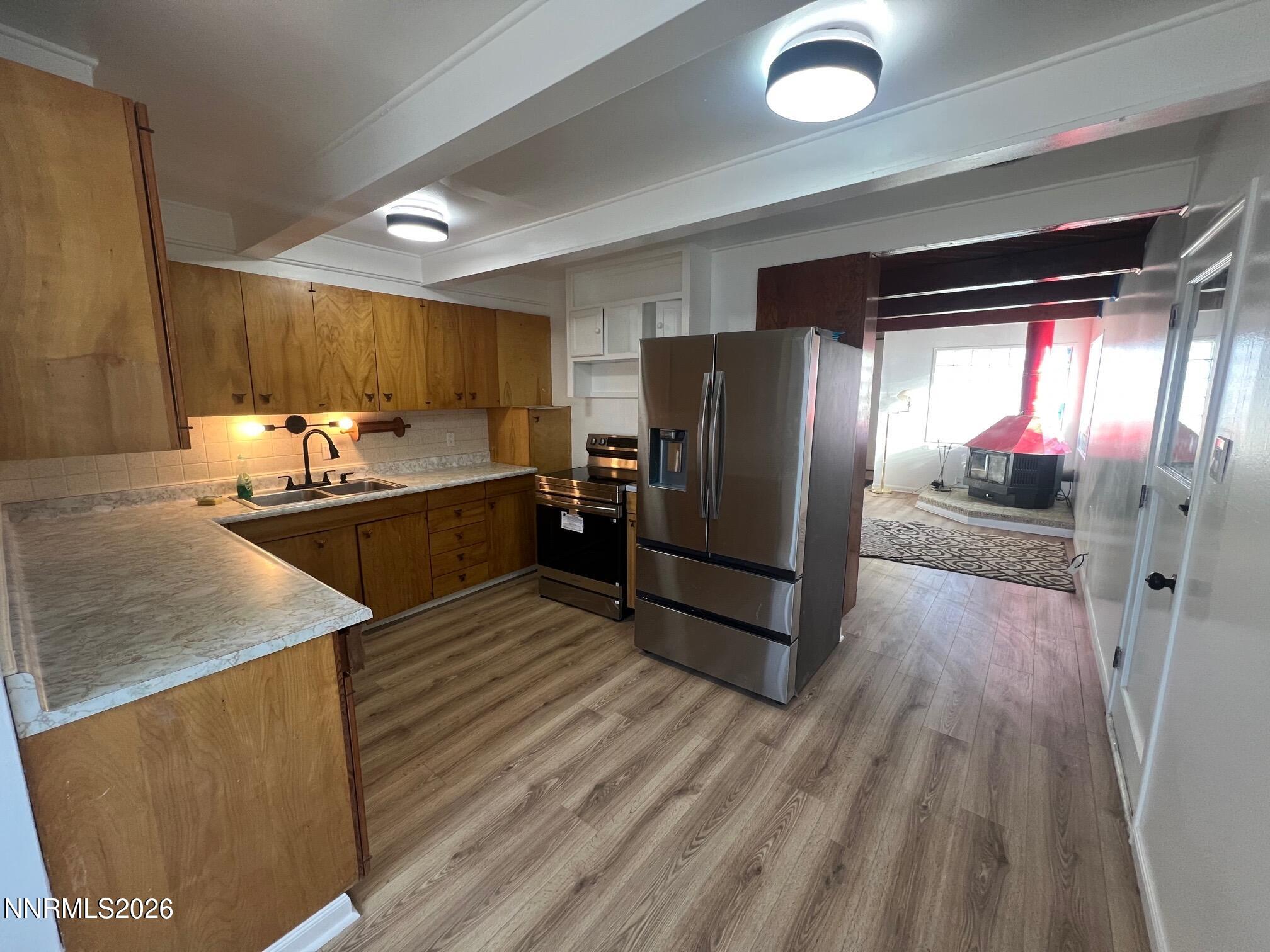 117 West 4th Street Hawthorne, NV 89415 - Photo 4 of 47 a kitchen with stainless steel appliances granite countertop a refrigerator and a sink