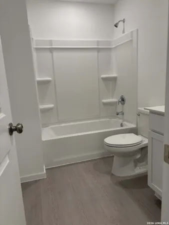 a bathroom with a toilet a sink and shower