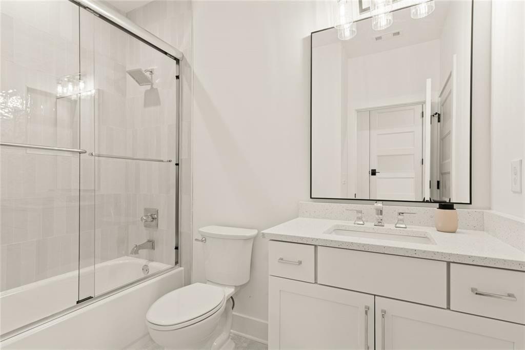 240 Highlands Ball Ground, GA 30107 - Photo 39 of 57 a bathroom with a sink a toilet and shower