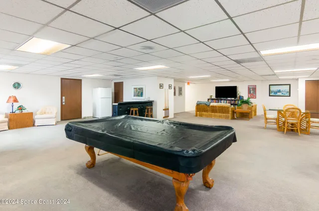 a living room with furniture and a table with wooden floor