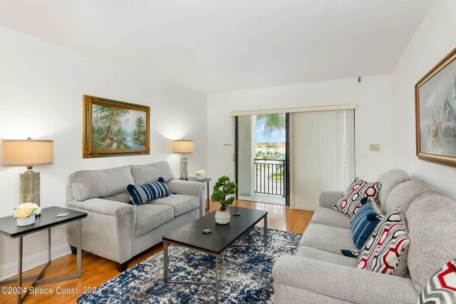 a living room with furniture and a lamp