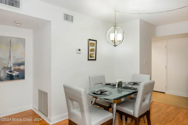 a dining room with furniture a window and wooden floor