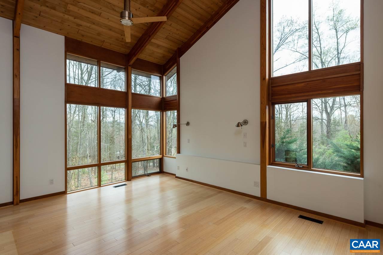 300 Turkey Ridge Road Charlottesville, VA 22903 - Photo 17 of 39 a view of an empty room with wooden floor and a window