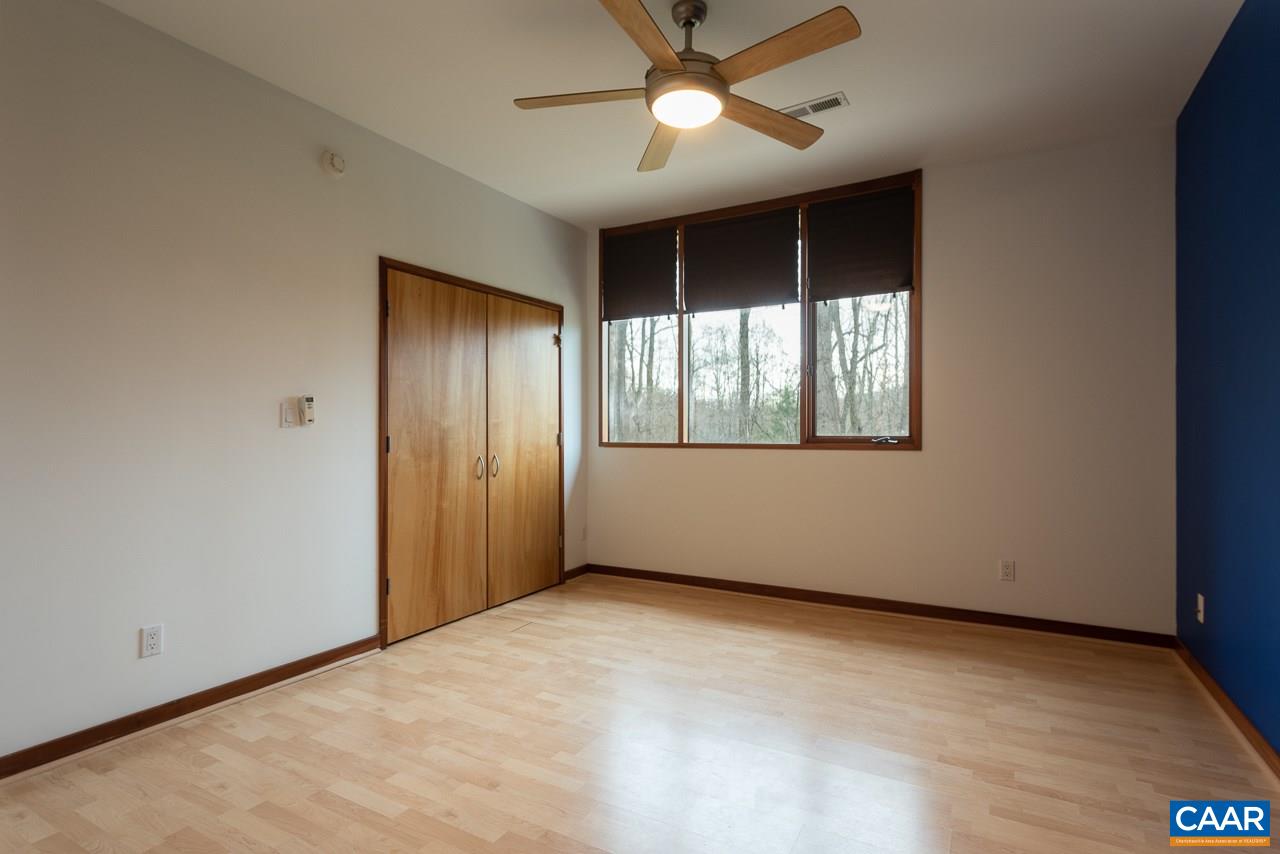 300 Turkey Ridge Road Charlottesville, VA 22903 - Photo 24 of 39 an empty room with windows and fan