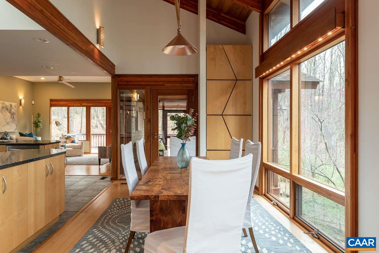 300 Turkey Ridge Road Charlottesville, VA 22903 - Photo 8 of 39 a view of a dining room with furniture a chandelier and wooden floor