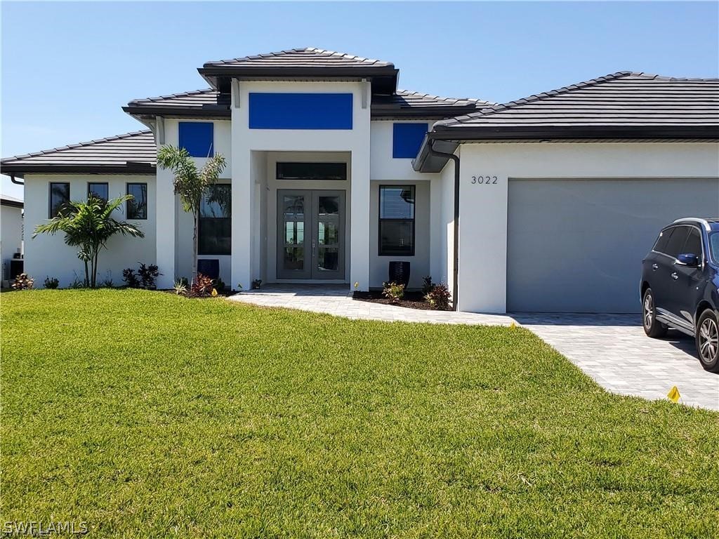 2107 Southwest 39th Street Cape Coral, FL 33914 - Photo 2 of 3 a front view of a house with a yard