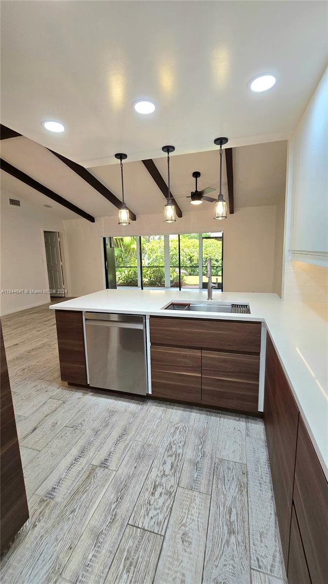 6727 Tiburon Circle Boca Raton, FL 33433 - Photo 18 of 36 a room with lot of wooden cabinets and a large window